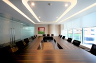 A modern conference room is prepared for meetings.