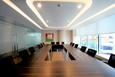 A modern conference room is prepared for meetings.