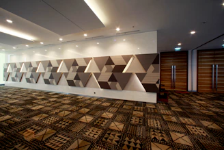 An empty room with geometric wall decoration.