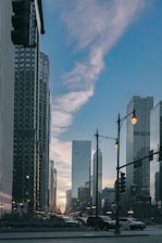 Skyscrapers line a city street at sunset.