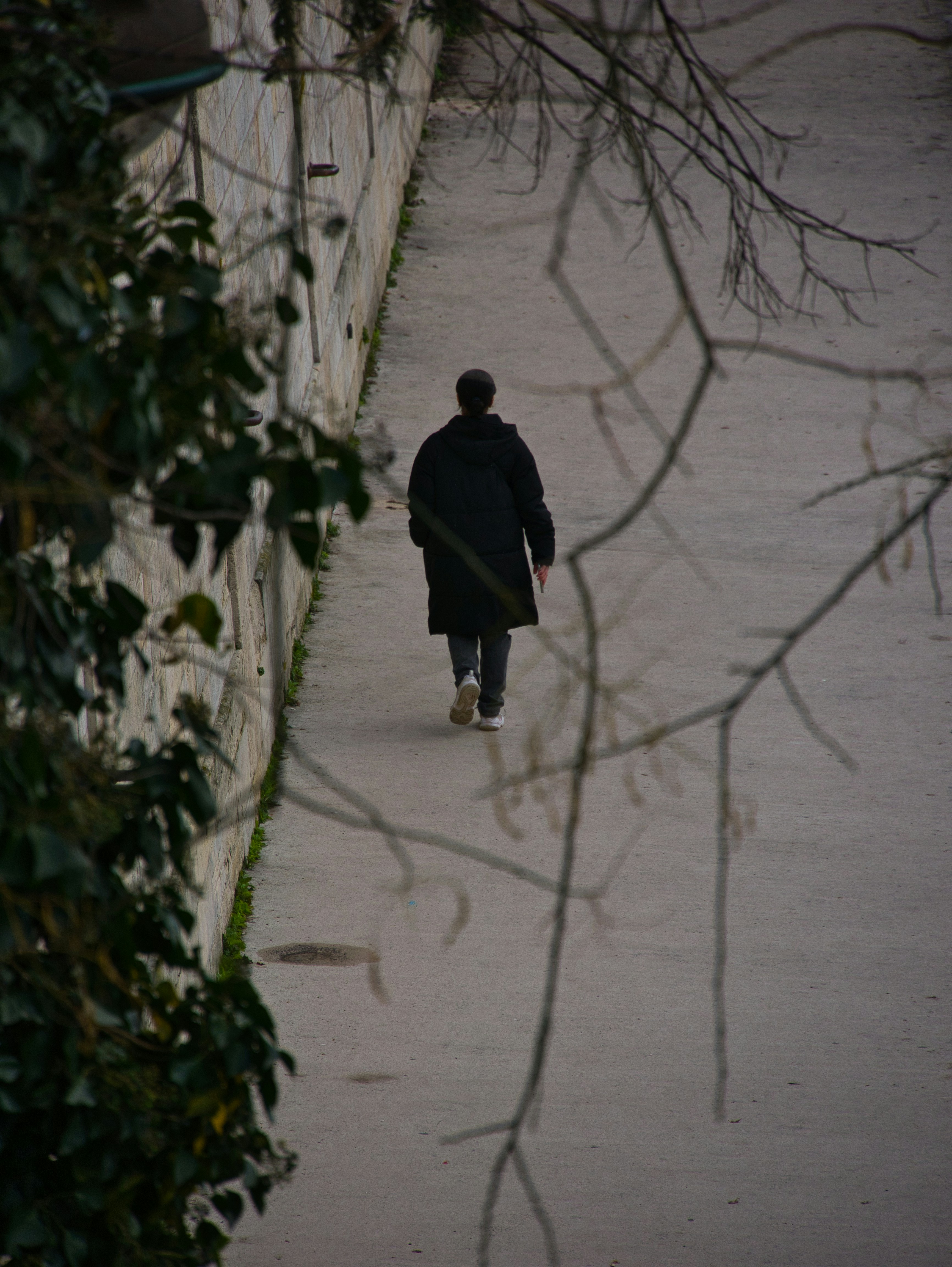 A person walks alone along a walkway.