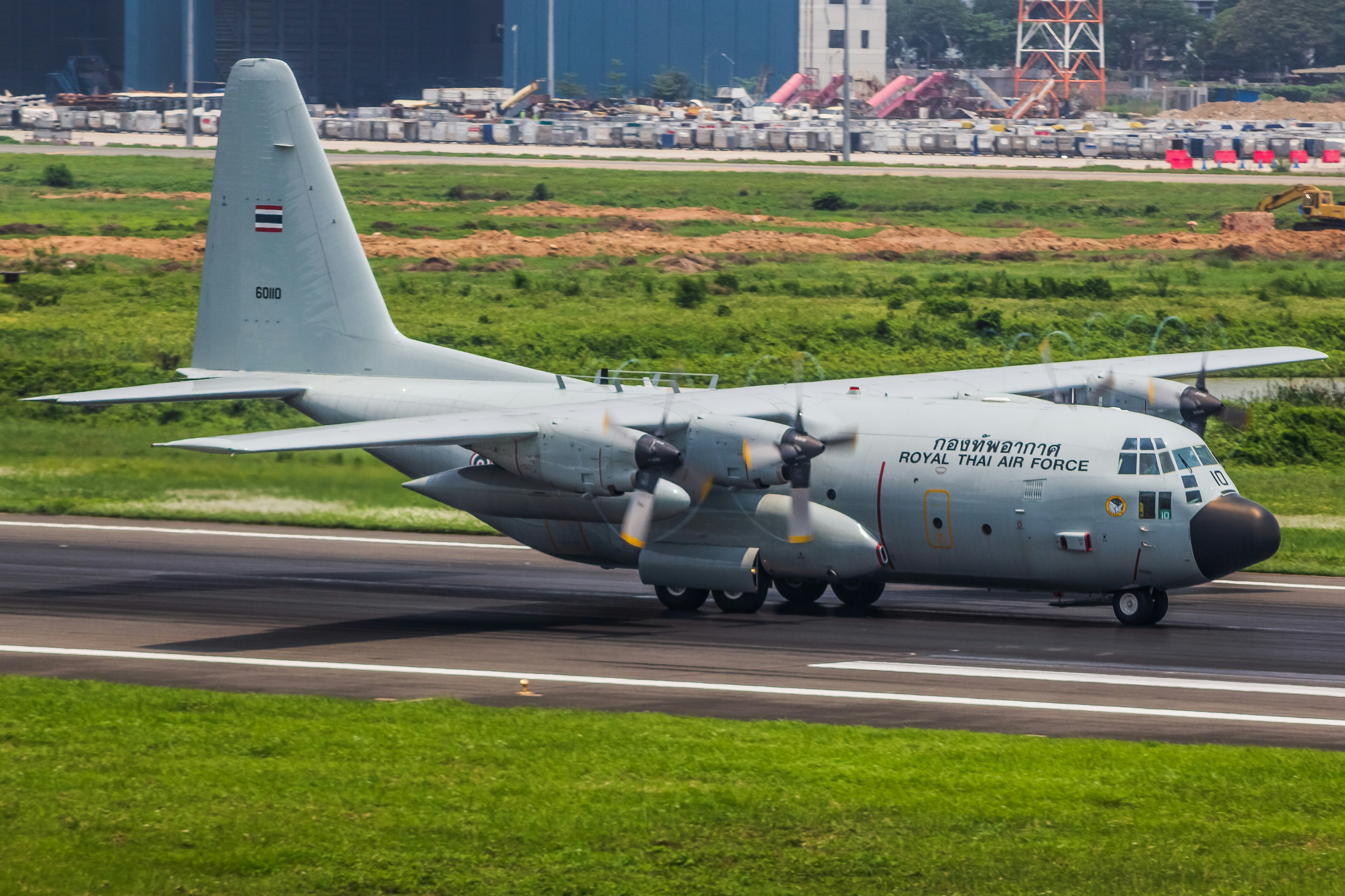 A military cargo plane taxis on the runway.