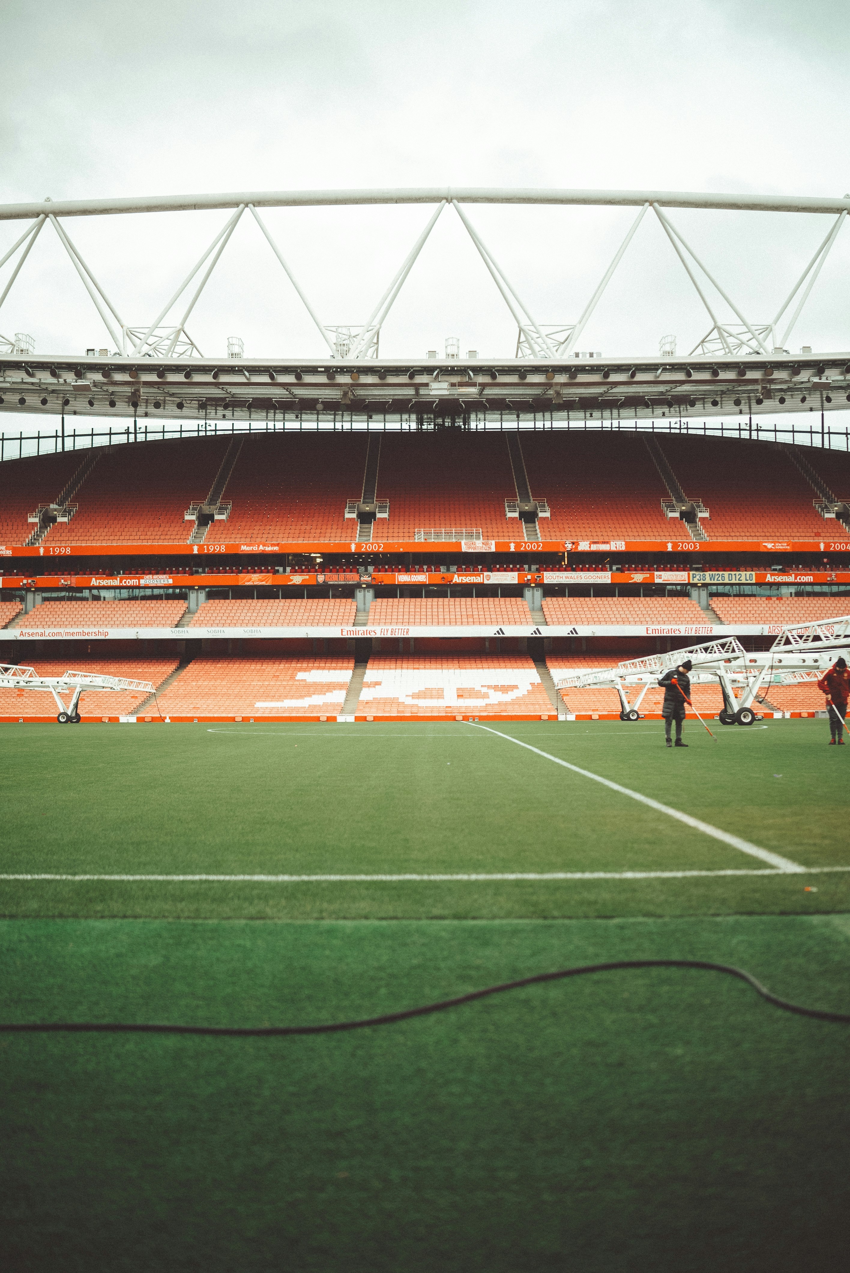 An empty soccer stadium on a cloudy day.