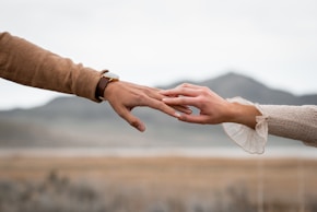 Two hands touch, showing connection and love.