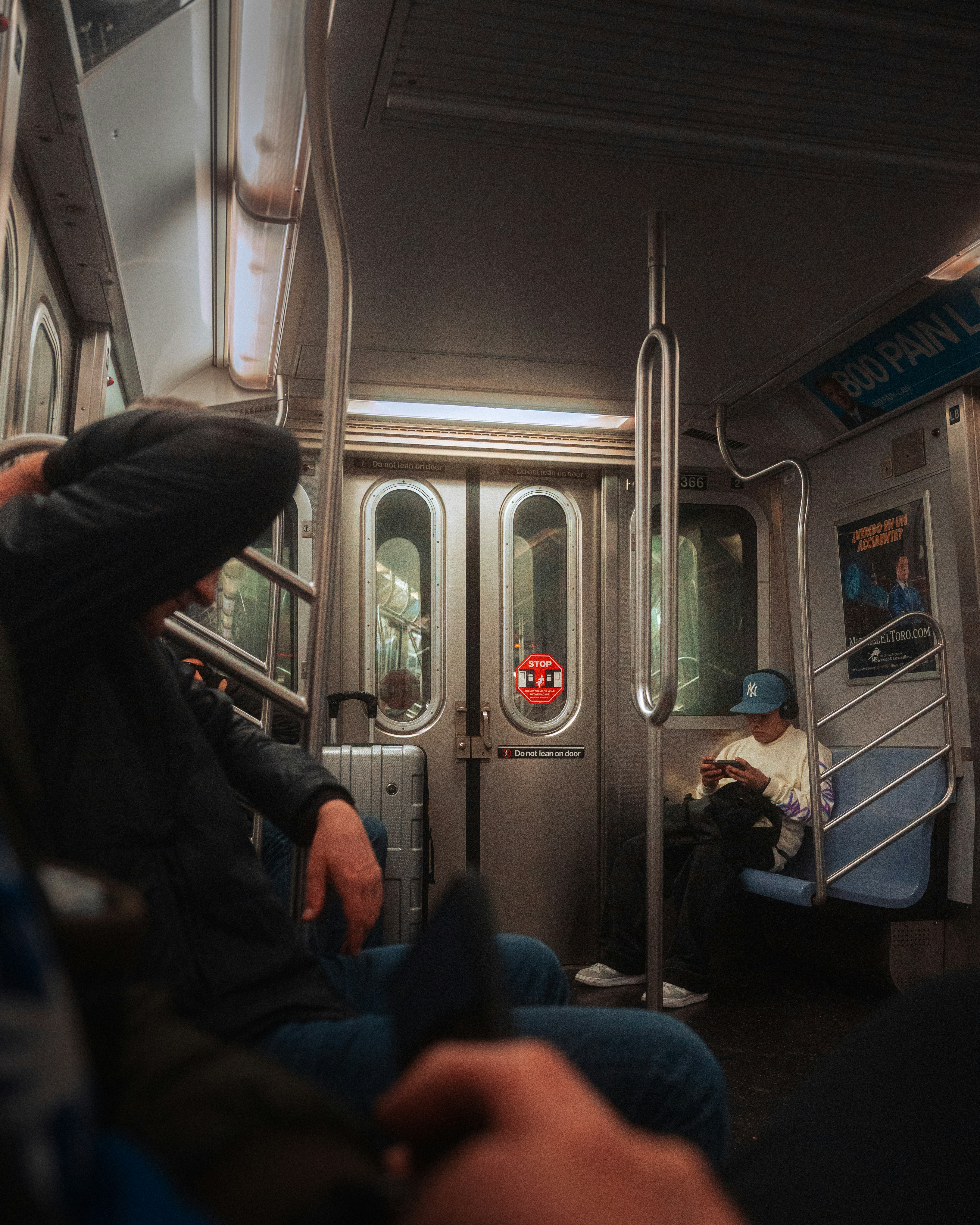 People sit on a subway train.