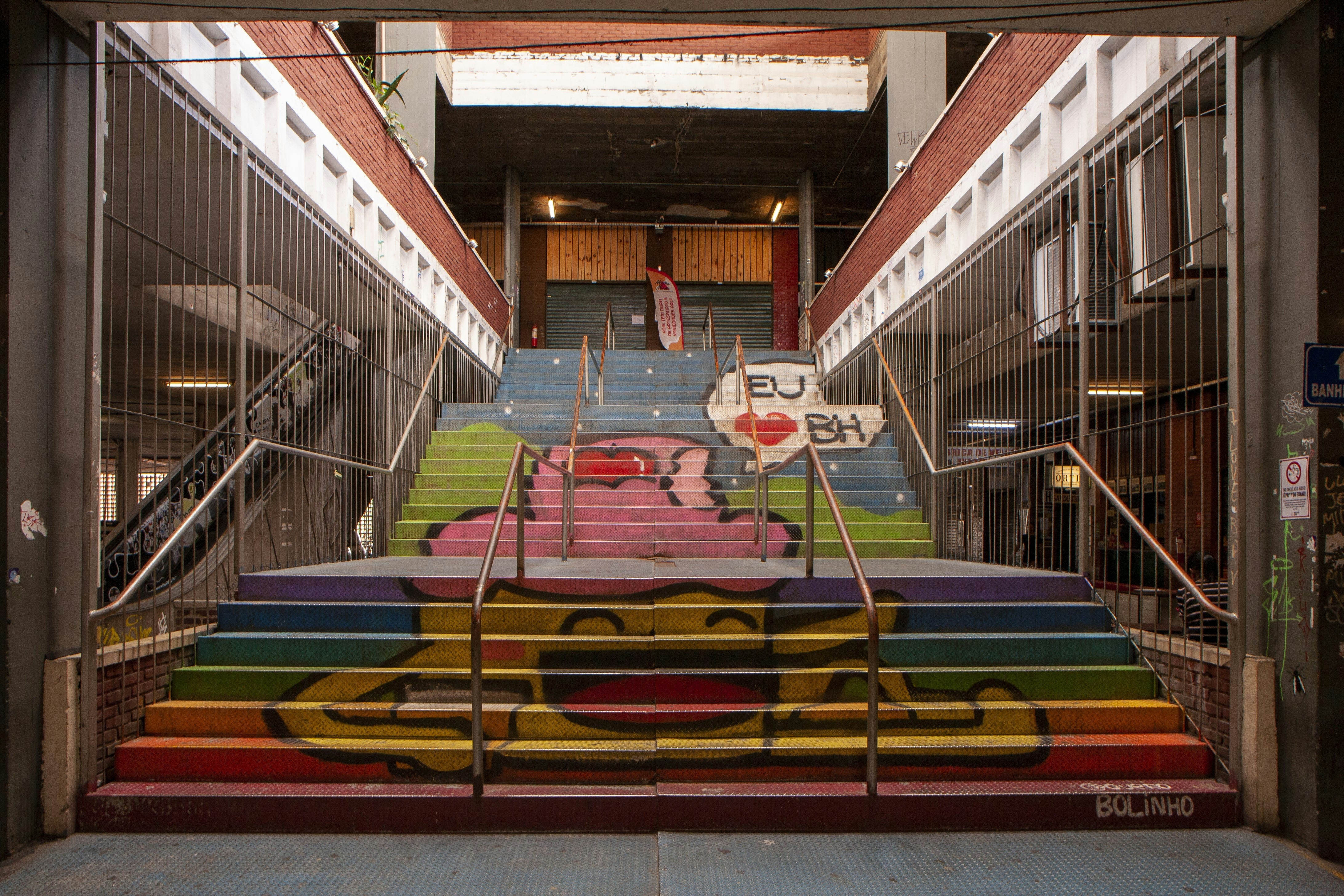 Rainbow-painted stairs lead into a building.