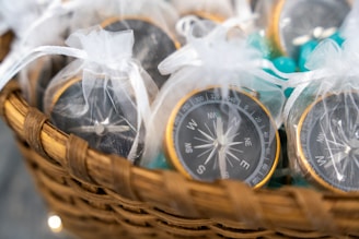 Compasses are gifts in white mesh bags.