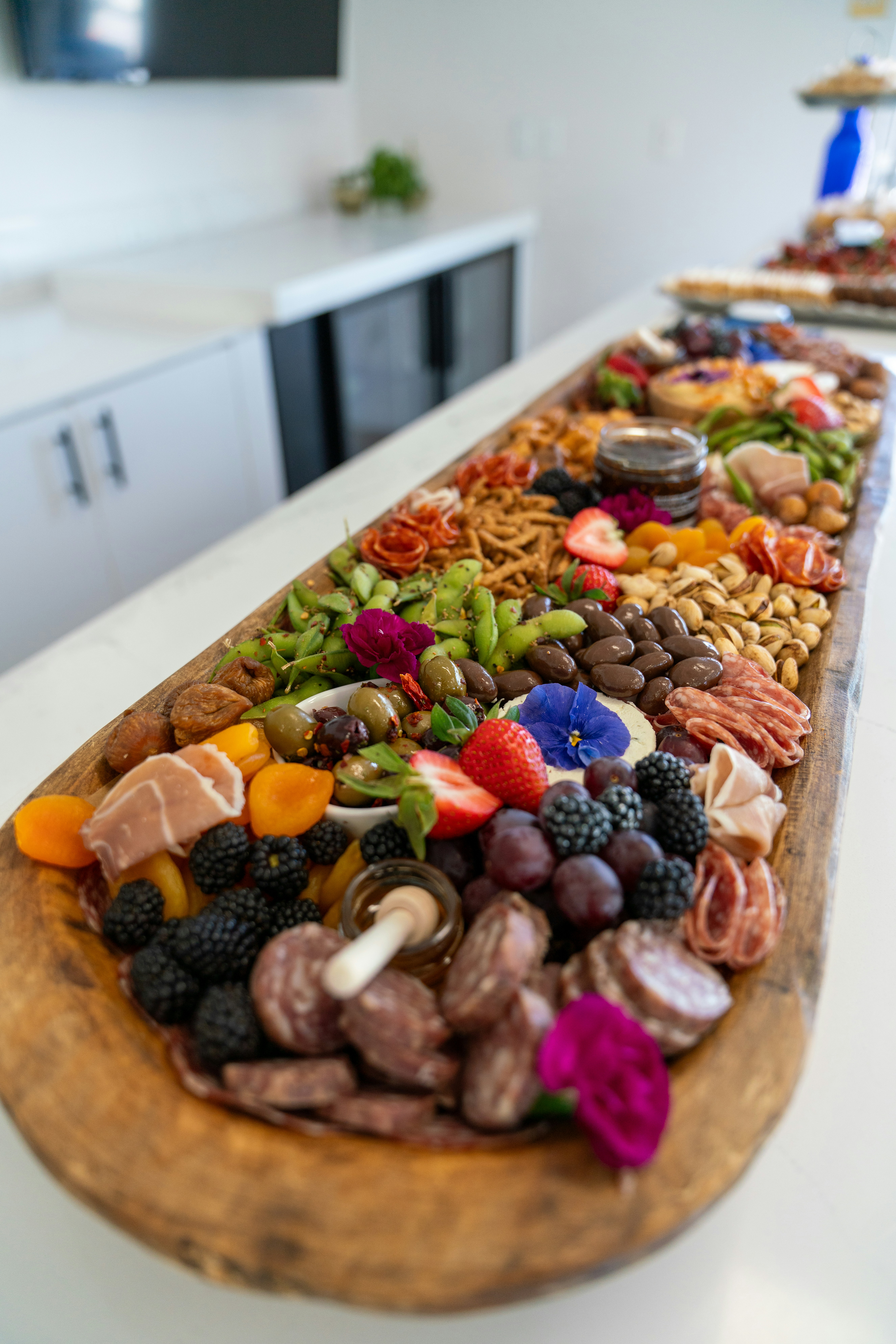 A large charcuterie board filled with delicious food.
