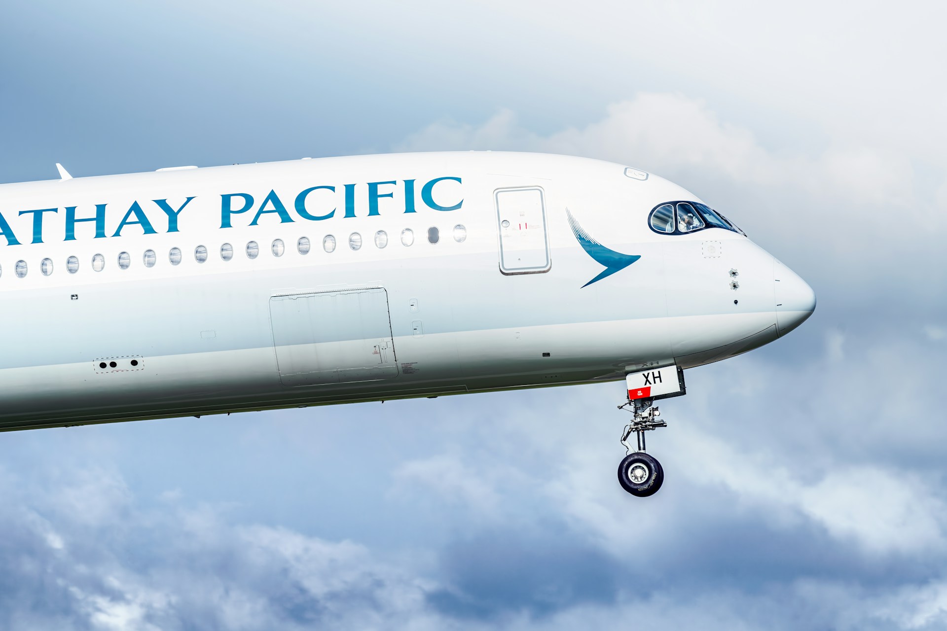 A cathay pacific airplane in flight.