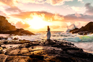 Woman enjoys the ocean sunset.