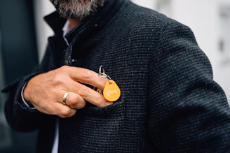 Man putting key in his jacket pocket.
