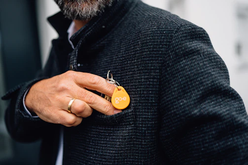 Man putting key in his jacket pocket.