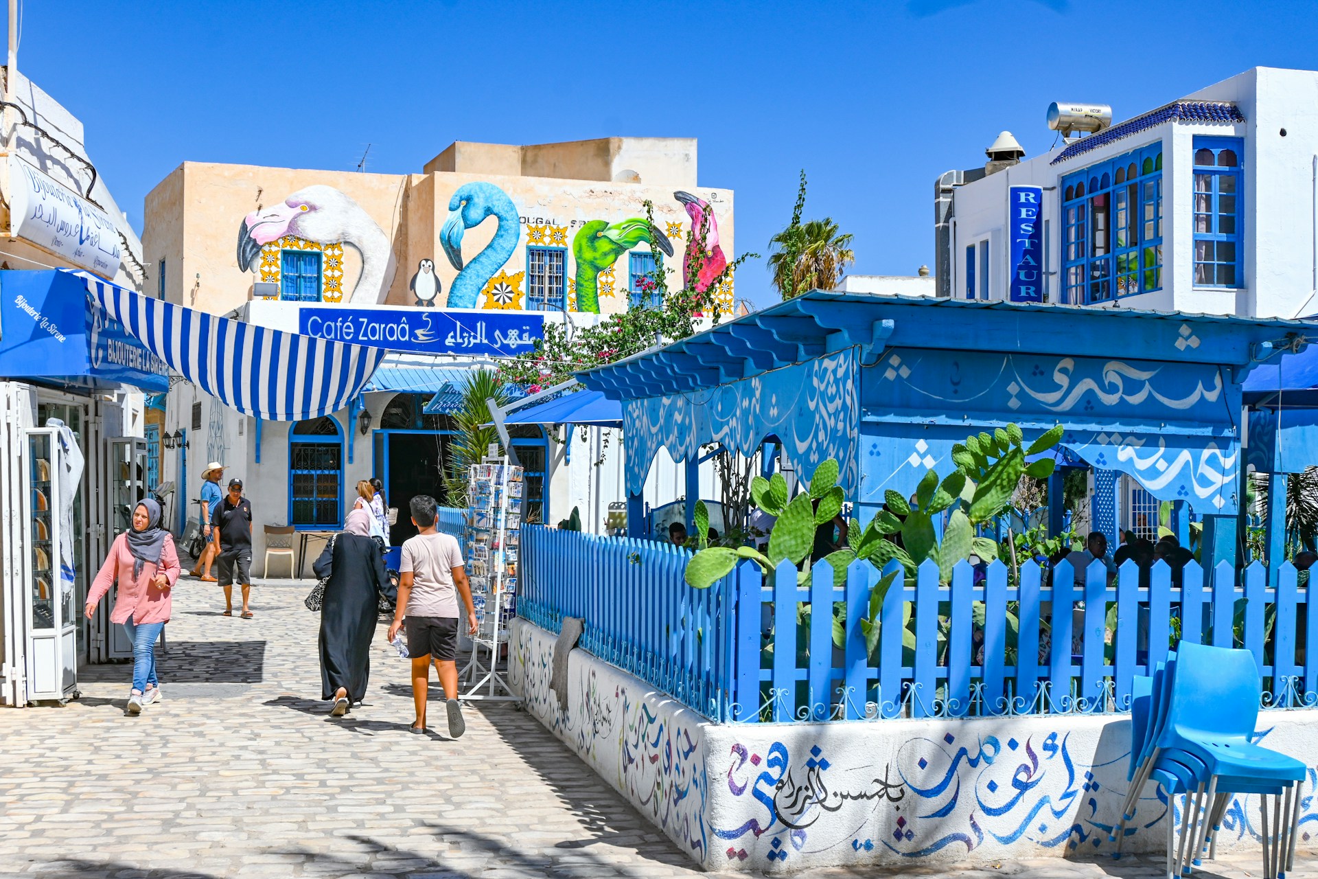 Charming, blue-themed buildings in a sunny village.