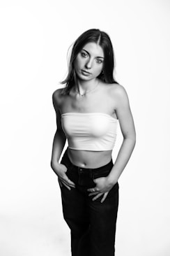 A woman poses in a black and white photo.