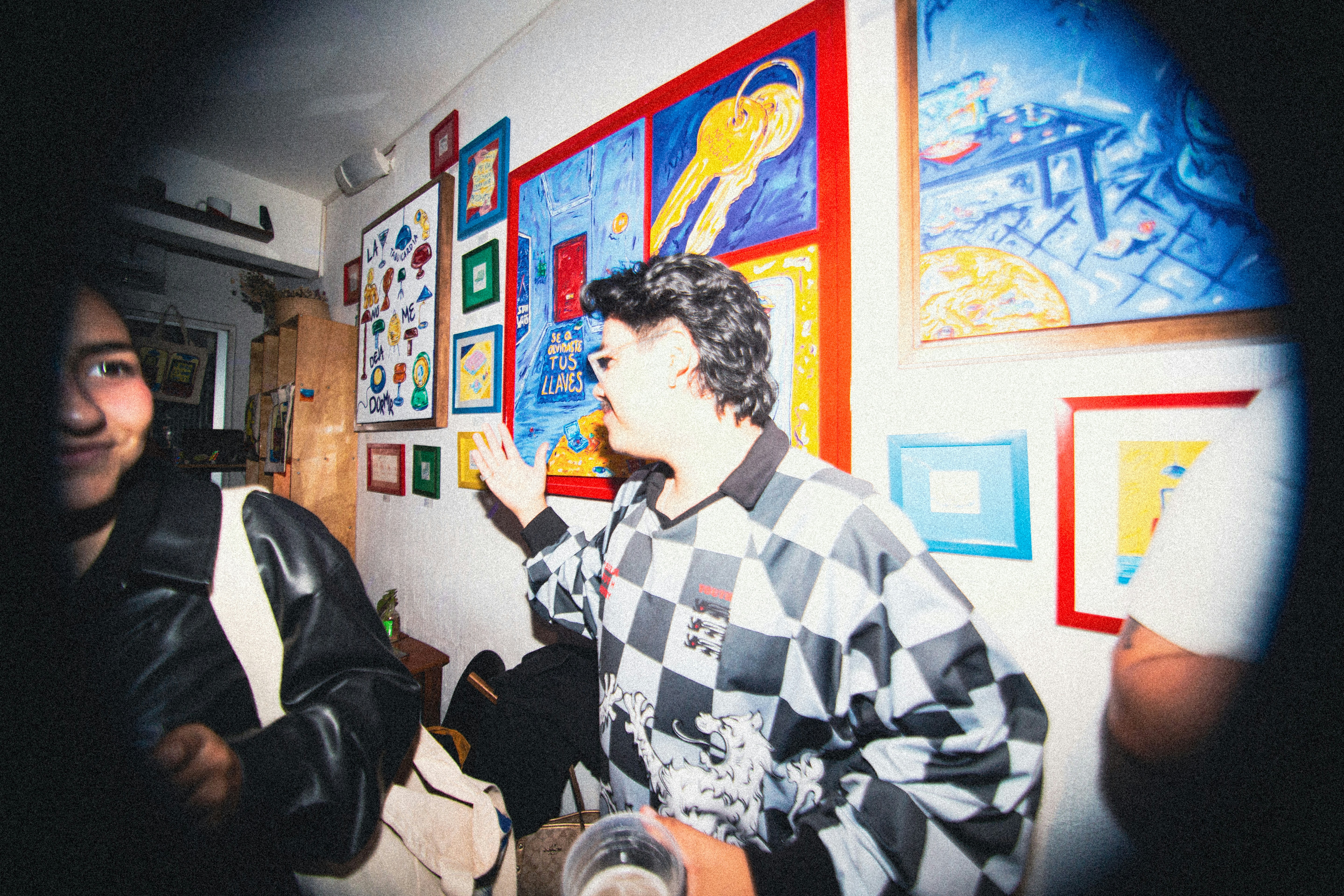 People in a room with colorful art on walls