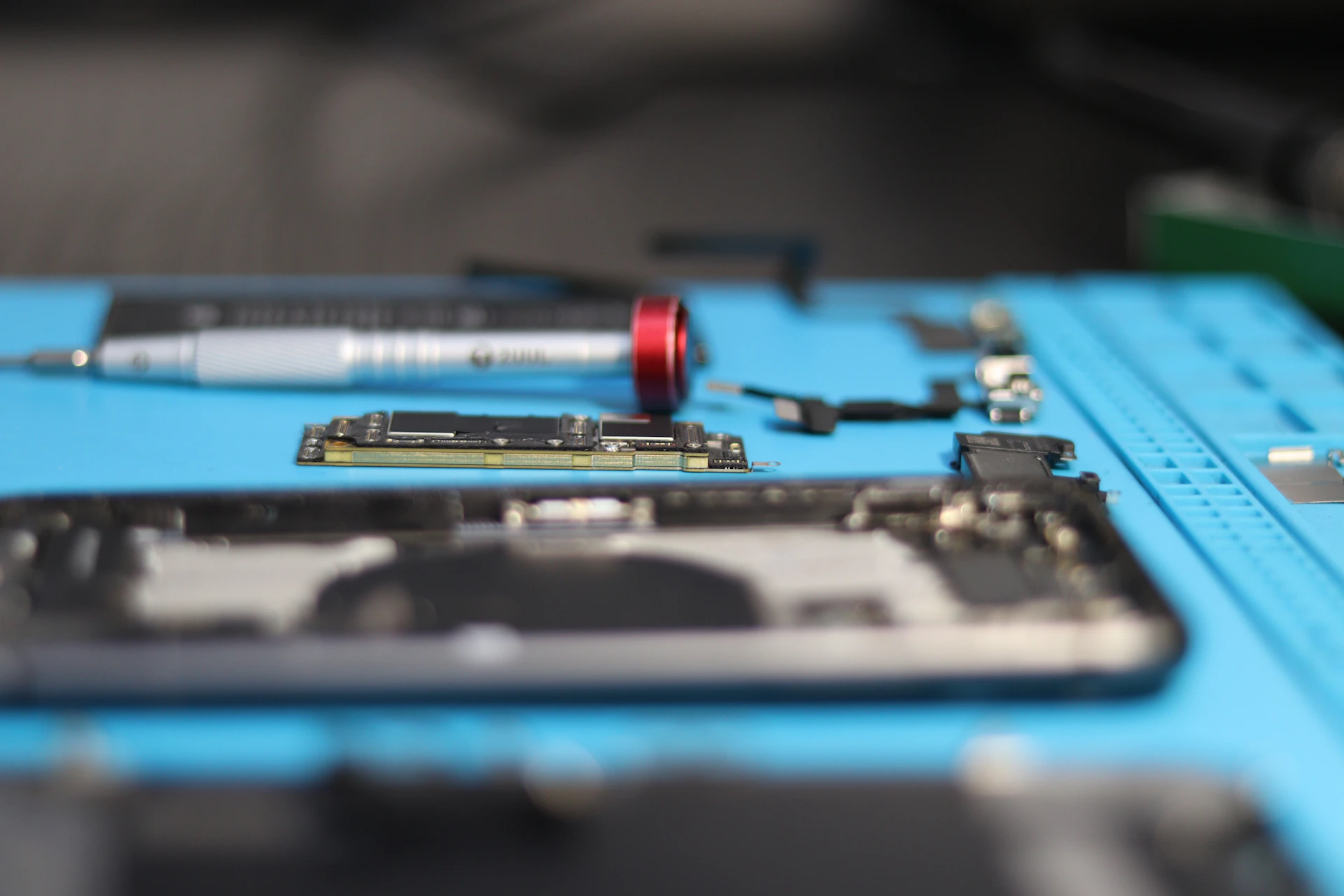 Phone parts are being disassembled for repair.