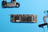 Disassembled phone circuit board, components visible.