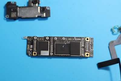 Disassembled phone circuit board, components visible.