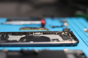 A smartphone is being disassembled for repairs.