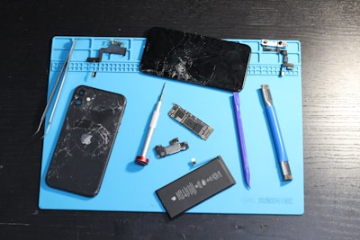 A broken phone disassembled for repair.