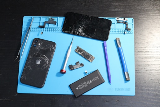 A broken phone disassembled for repair.