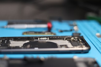 A disassembled phone is being repaired.