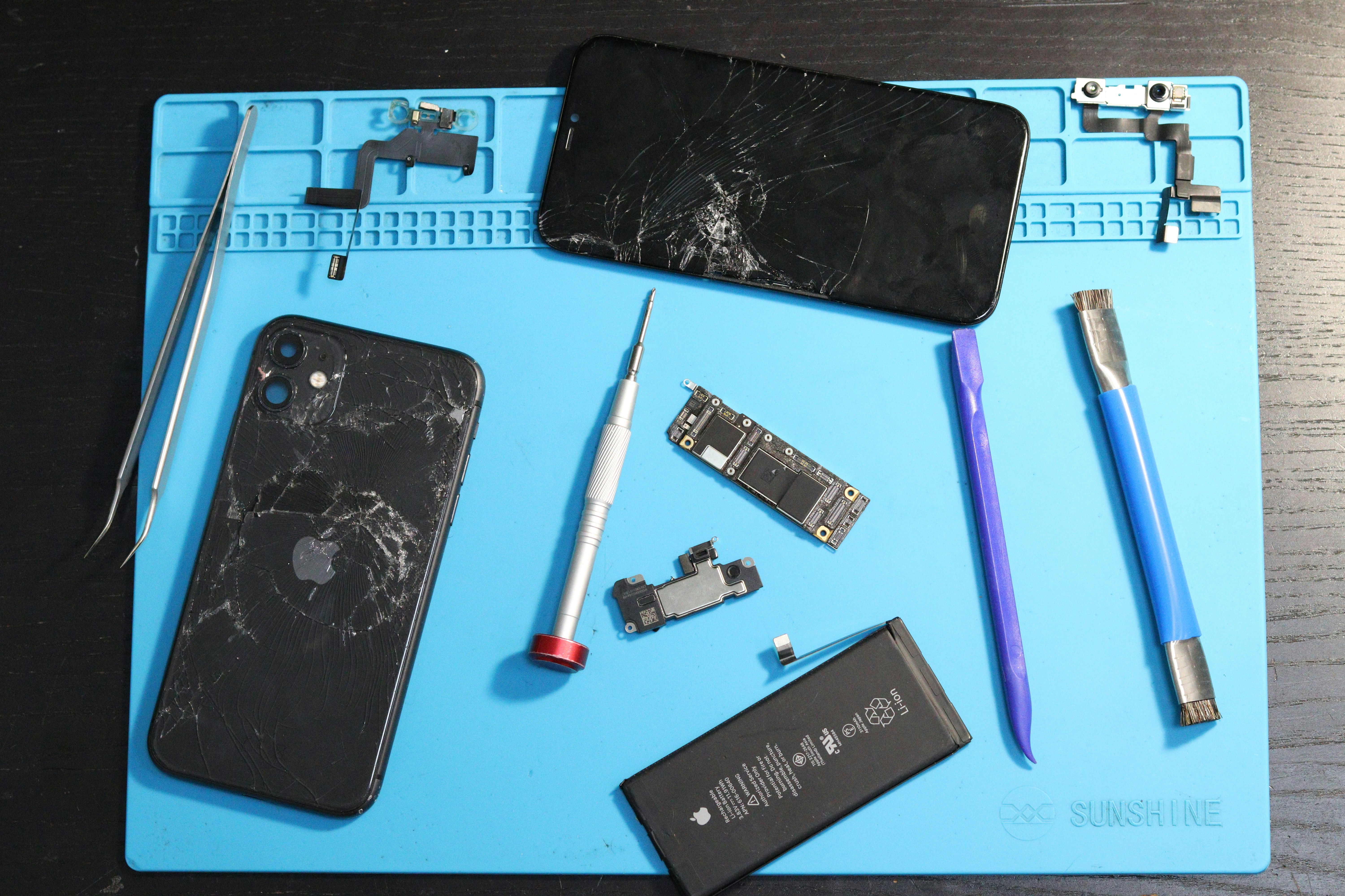 Phone components are laid out for repair.