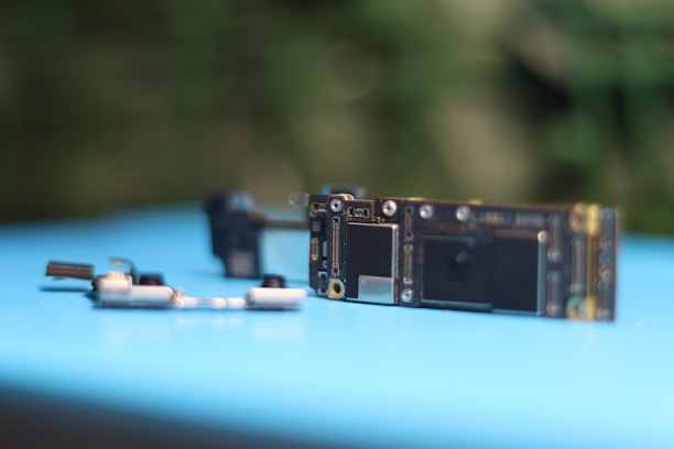 Phone components are placed on a blue surface.