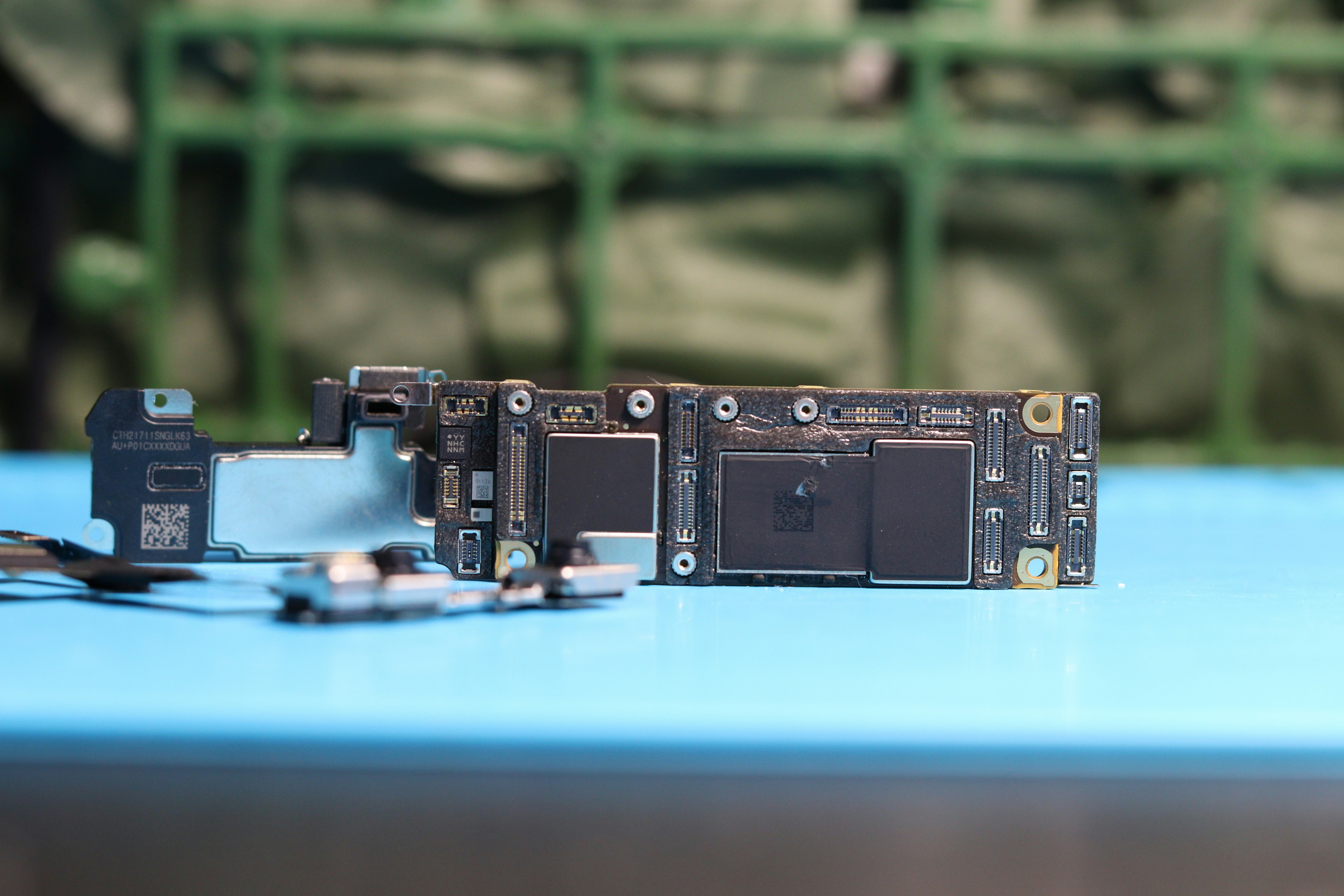 internal iPhone components showing Face ID sensors and logic board - how long does iphone screen repair take
