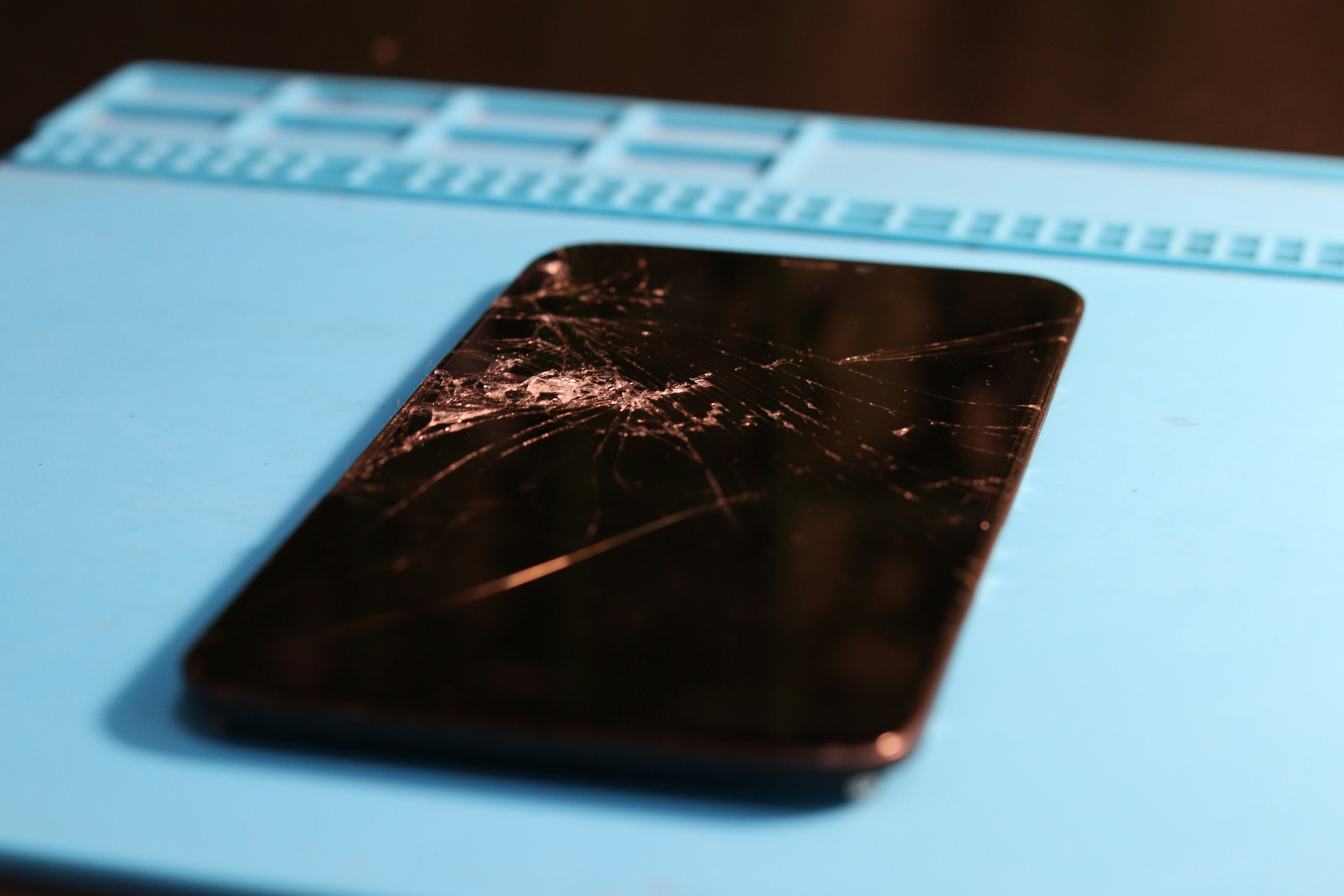 The phone's screen is shattered and broken.