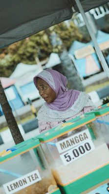 Woman selling mango juice at a market stall.