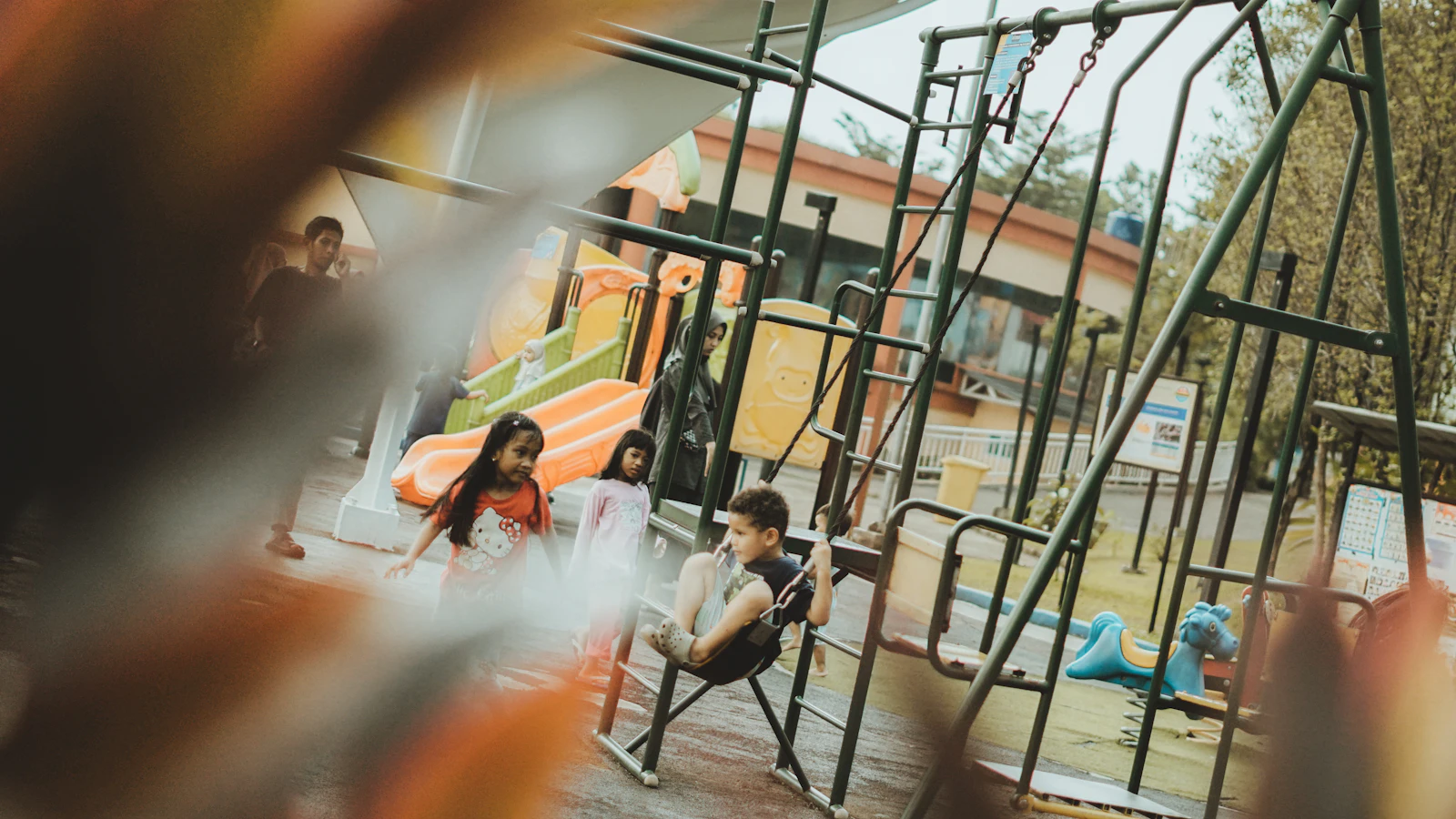 Children playing on swings during the school break