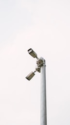 Two security cameras are mounted on a pole.