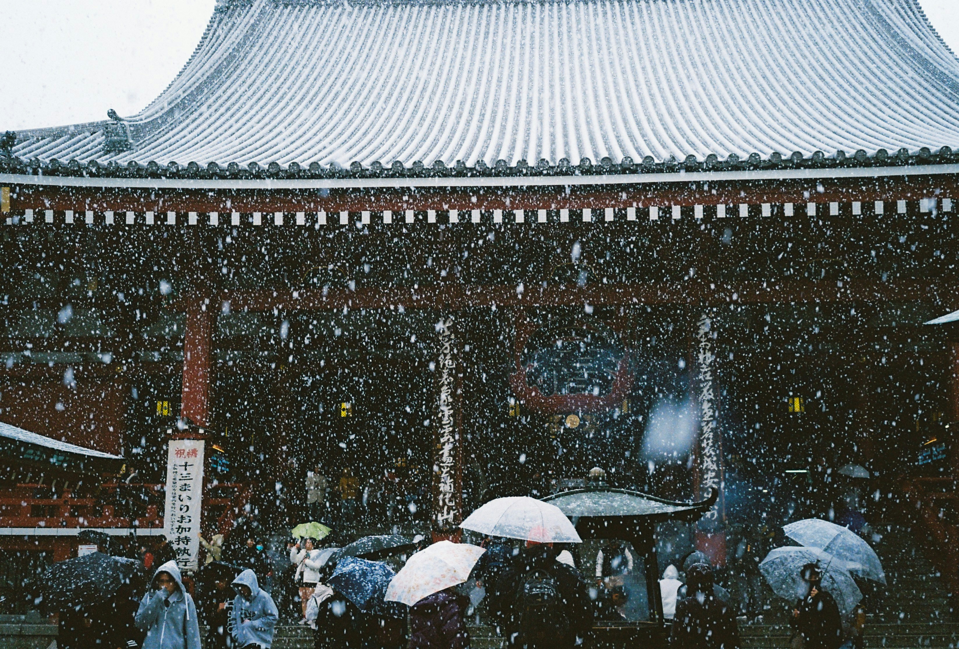 Snow falls on a japanese temple.