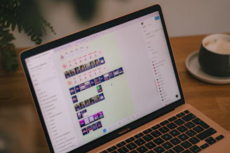 A laptop screen displays video editing software.