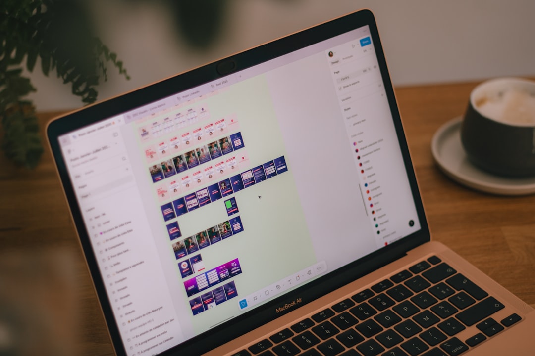 A laptop screen displays video editing software.,