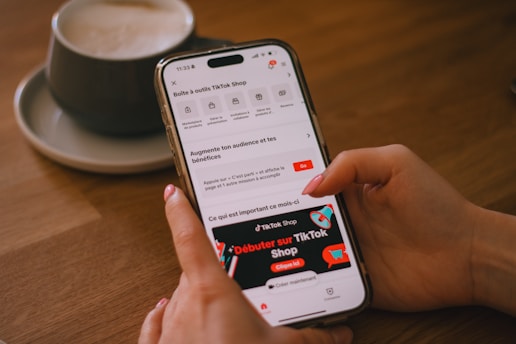 A person uses a phone with the tiktok shop app.