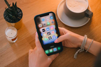 Woman uses a smartphone on a table