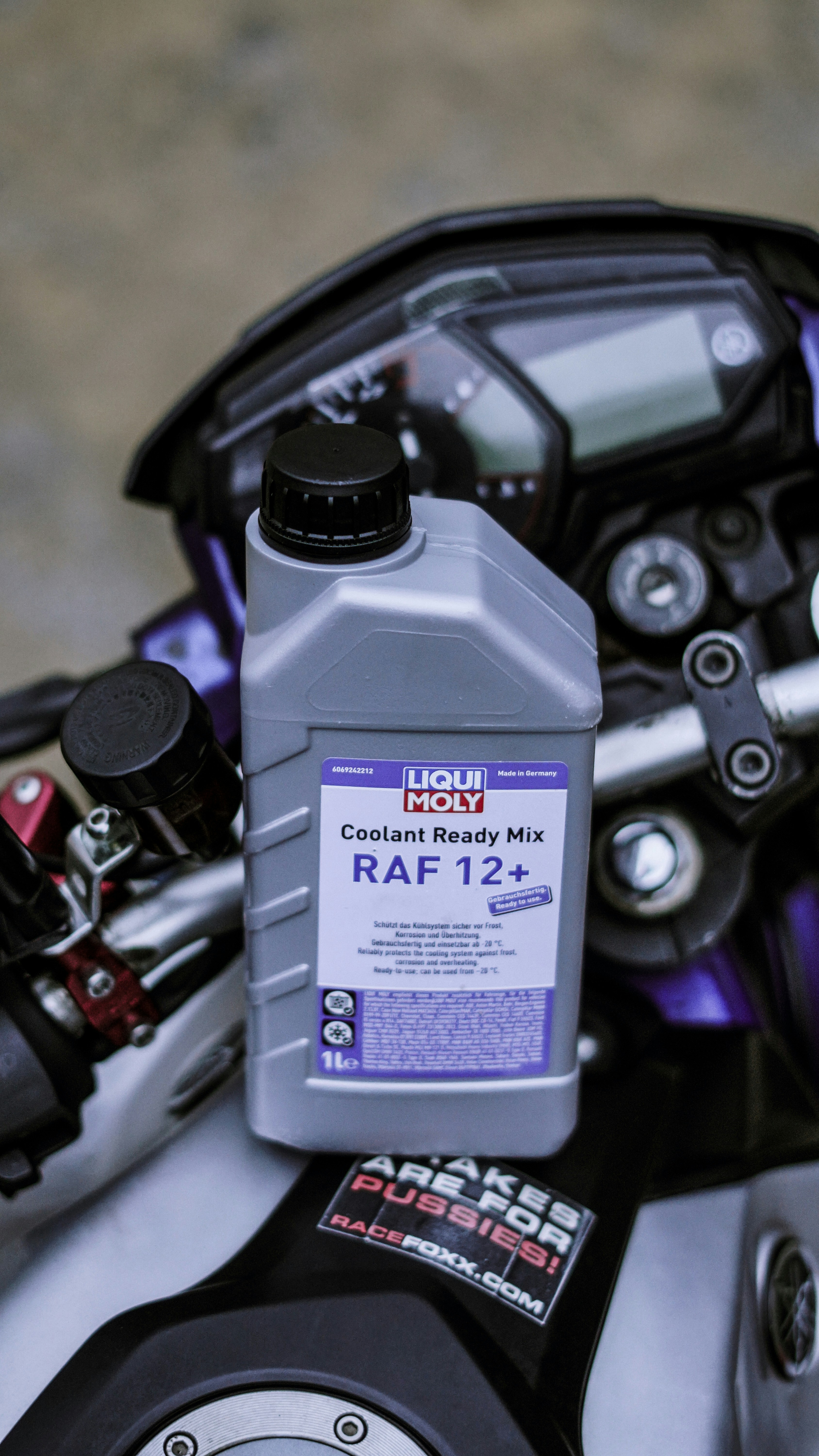 Coolant bottle is placed on a motorcycle.