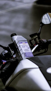 A bottle of coolant on a motorcycle.