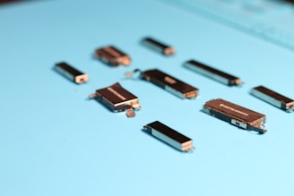 Small electronic components are scattered on blue surface.