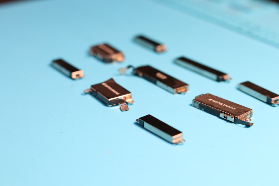 Small electronic components are scattered on blue surface.,
