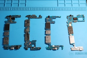 Phone circuit boards are displayed on a blue mat.