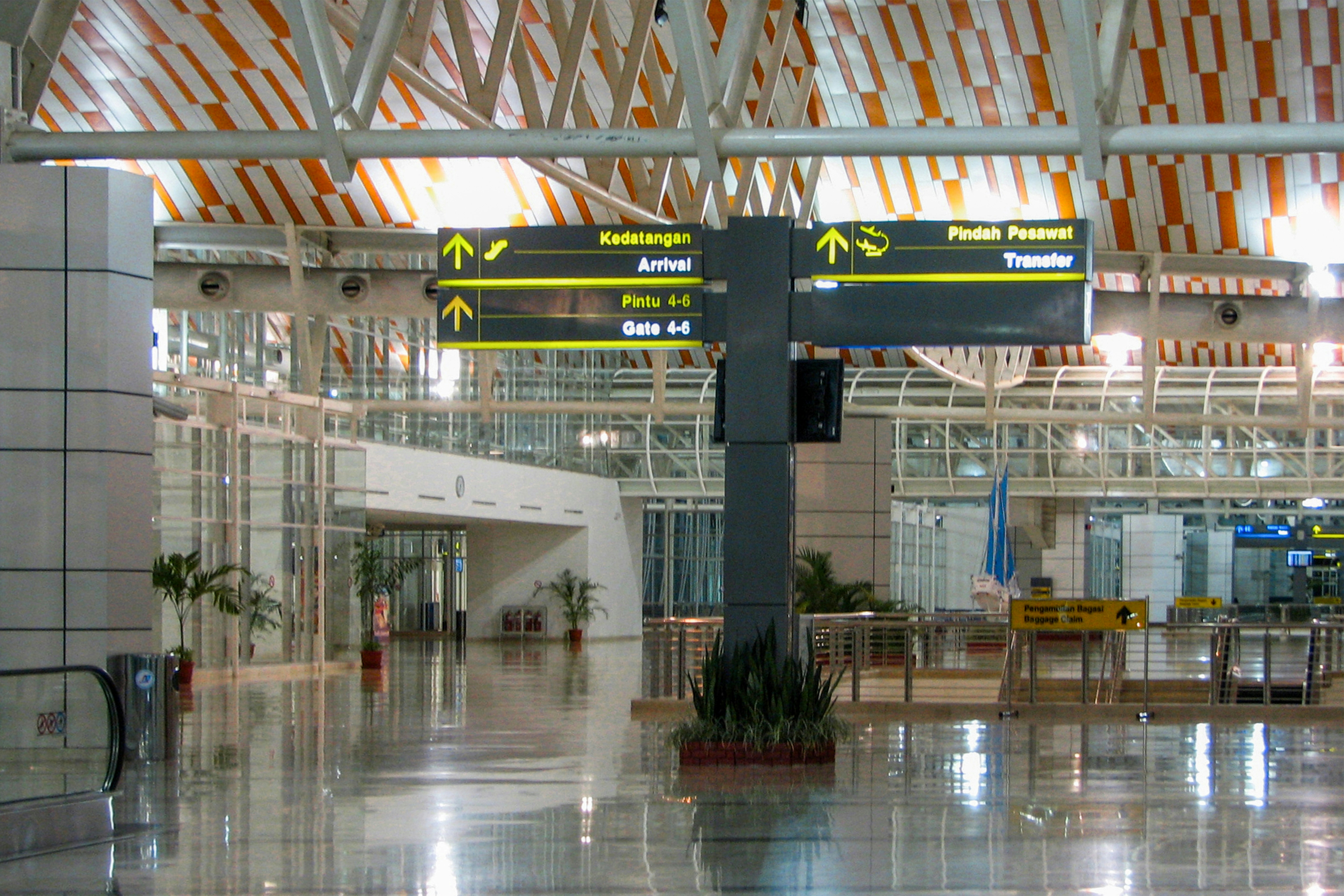 Inside an airport terminal, with signage.