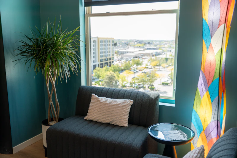 A cozy, plant-filled therapy room corner