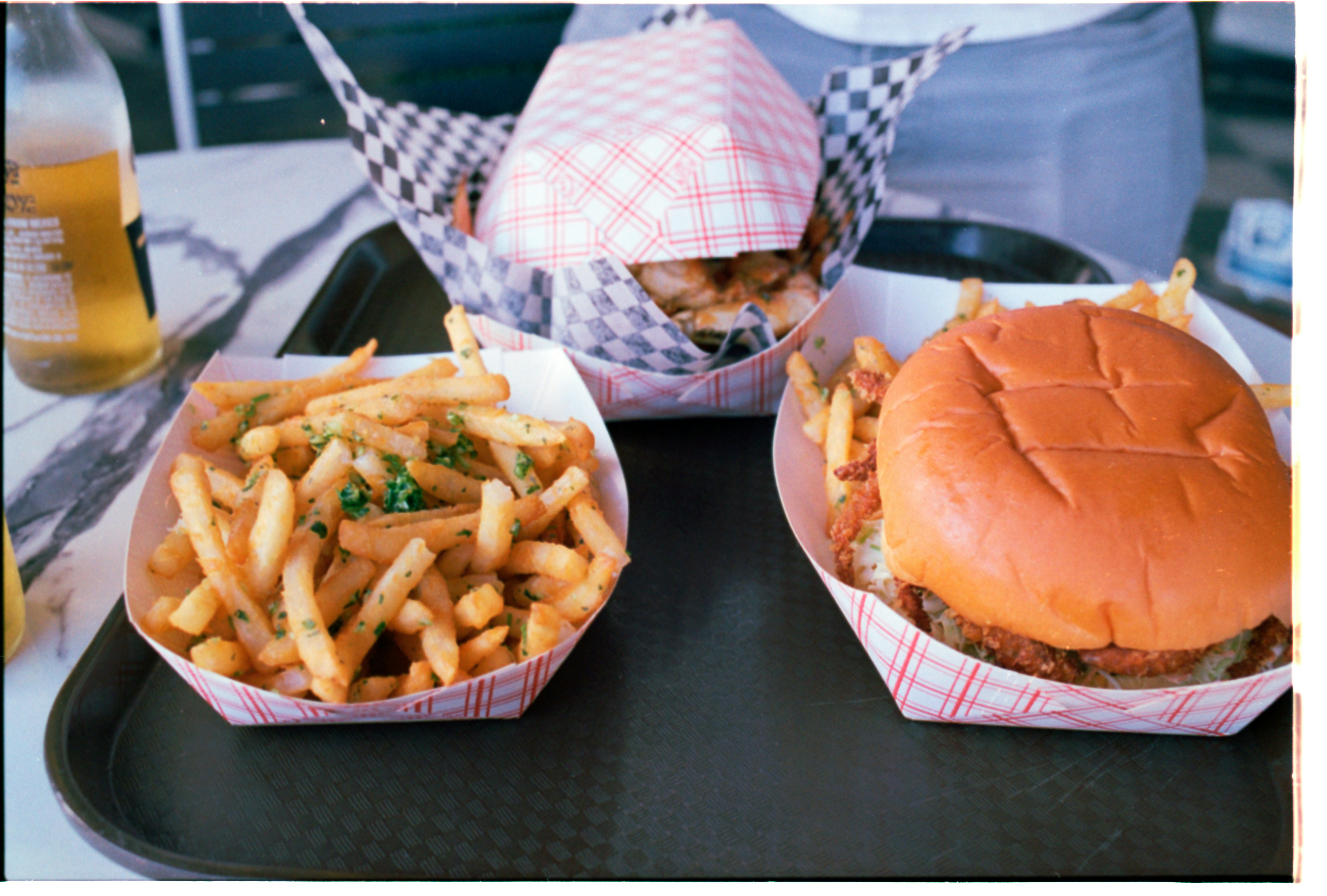 Burger and fries in paper trays ready to serve