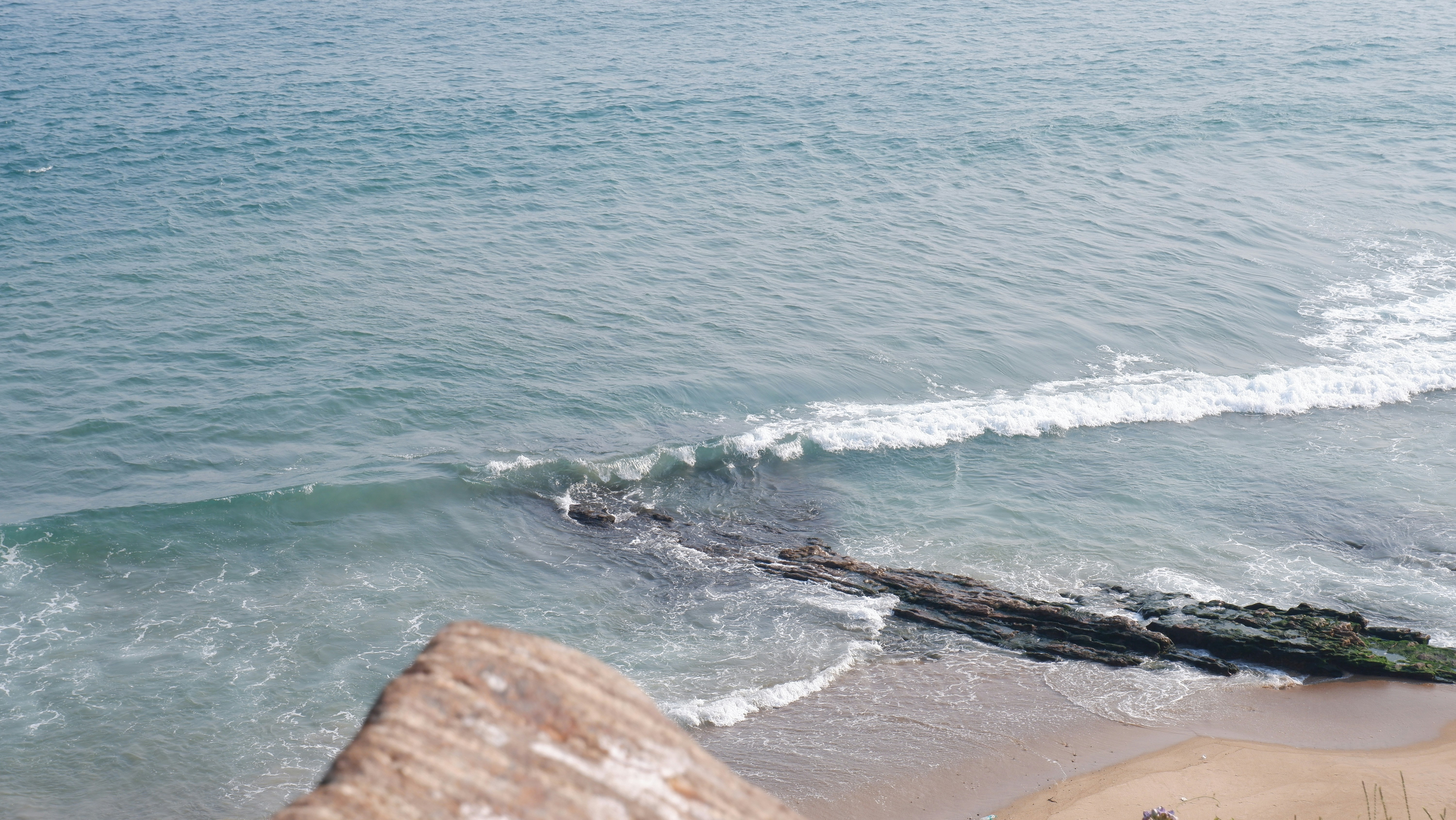 Waves crash on a rocky shore.