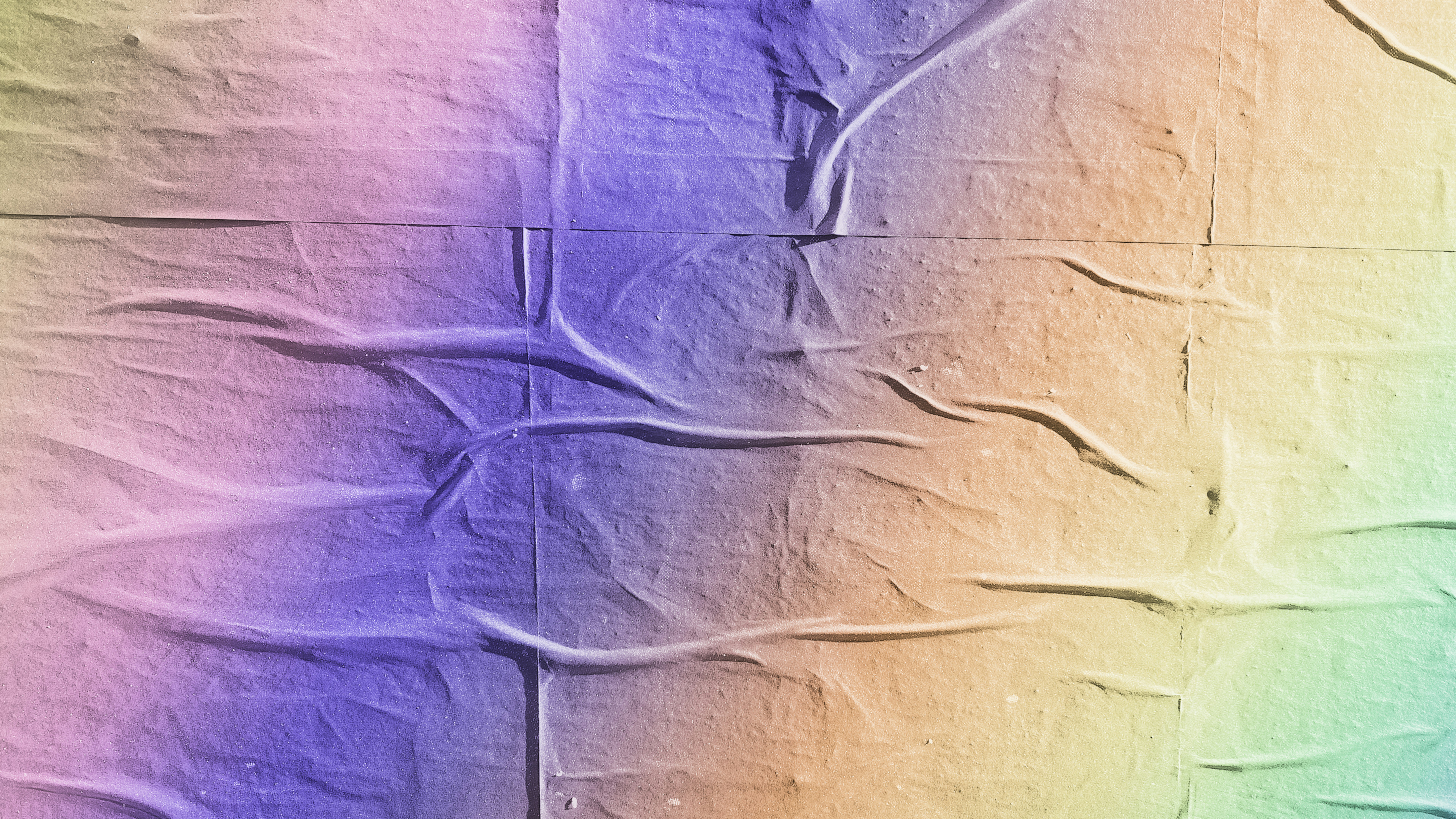 Wrinkled paper with a colorful gradient background.