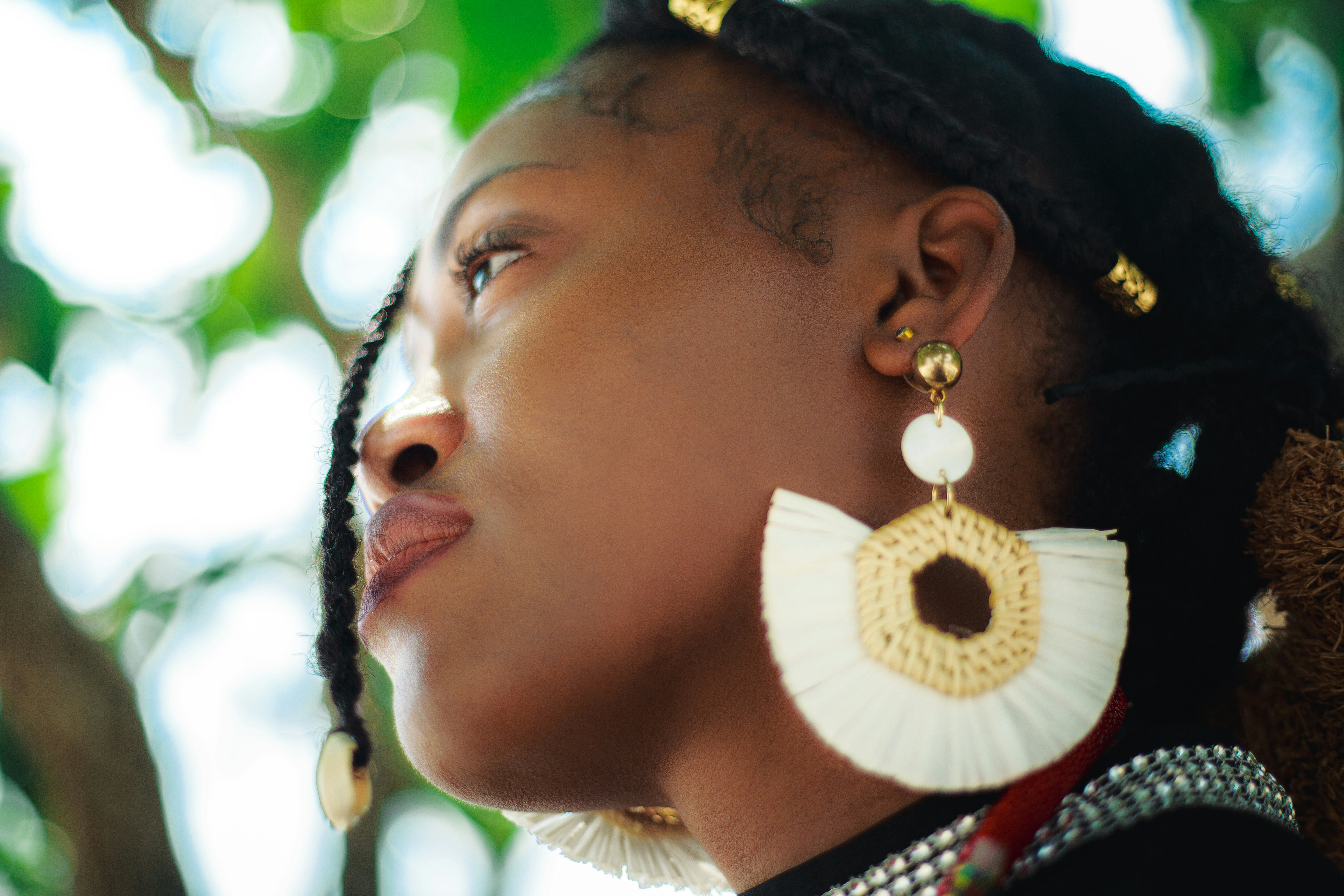 Woman wearing beautiful white earrings looks up.