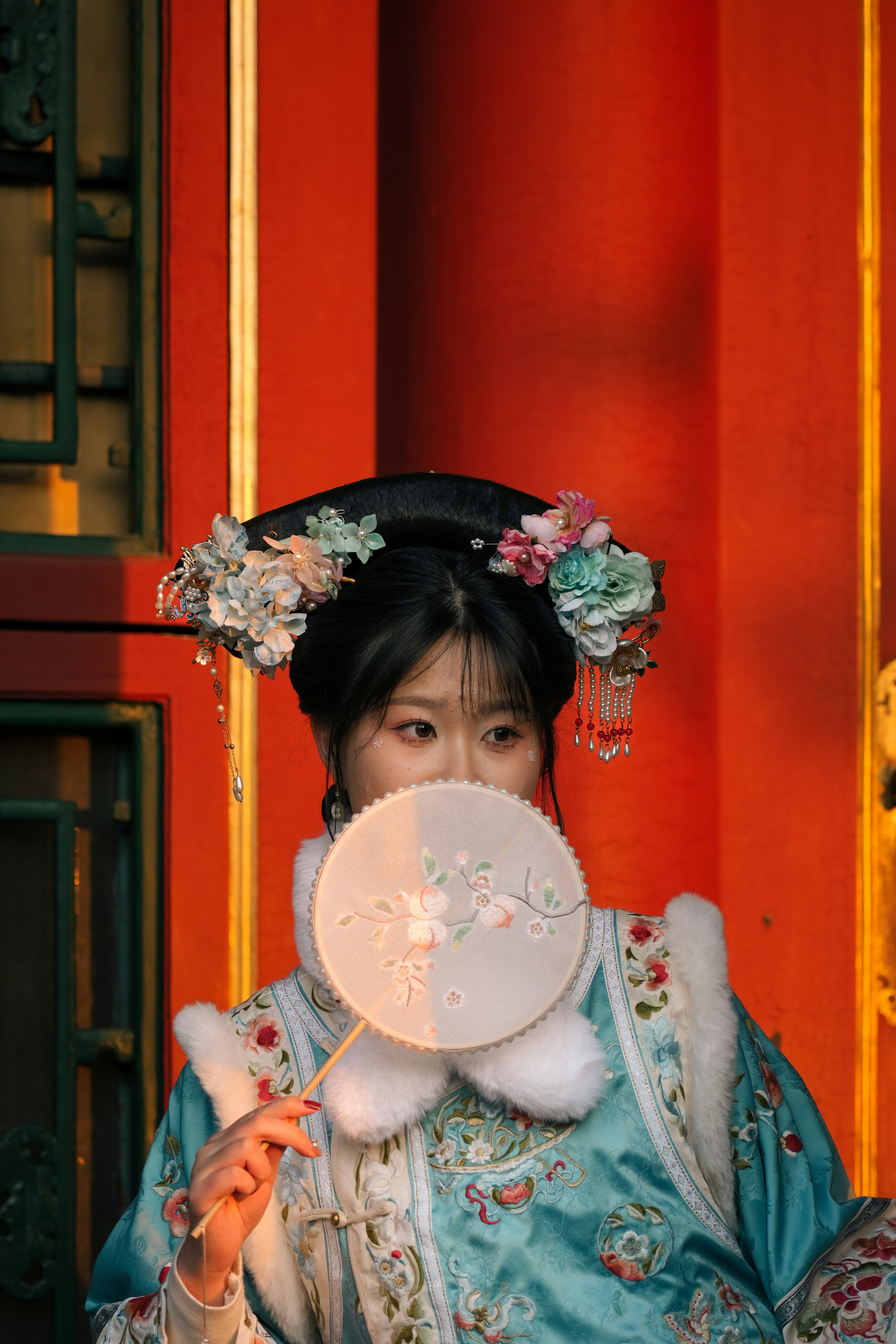 A woman in traditional chinese costume poses.